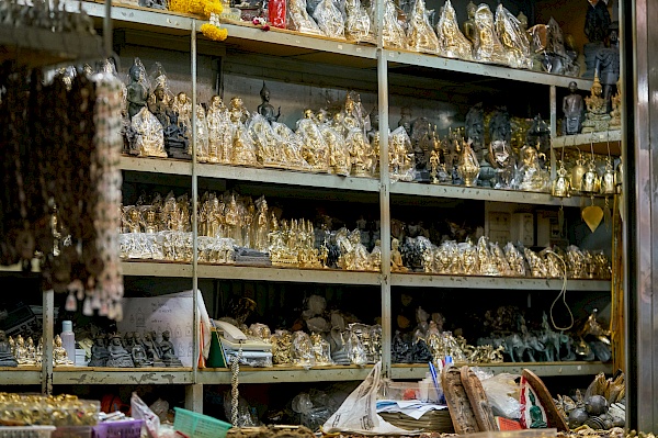Regale voller Glücksbringer auf dem Amulettmarkt in Bangkok